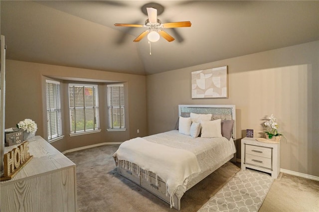 bedroom with lofted ceiling, ceiling fan, and light carpet