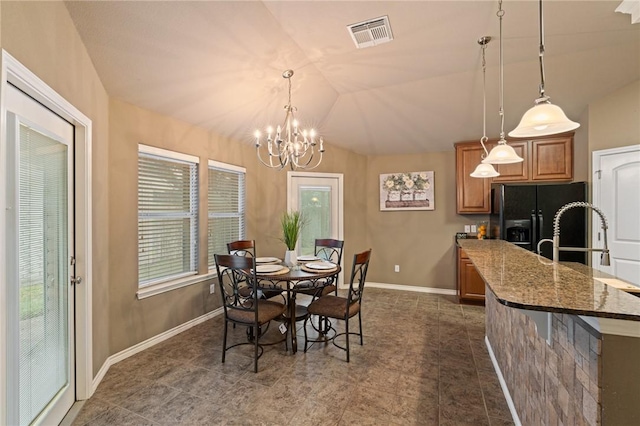 dining area with an inviting chandelier and lofted ceiling