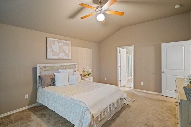 carpeted bedroom with ceiling fan, ensuite bathroom, and vaulted ceiling