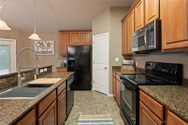 kitchen with sink, dark stone countertops, black appliances, and pendant lighting