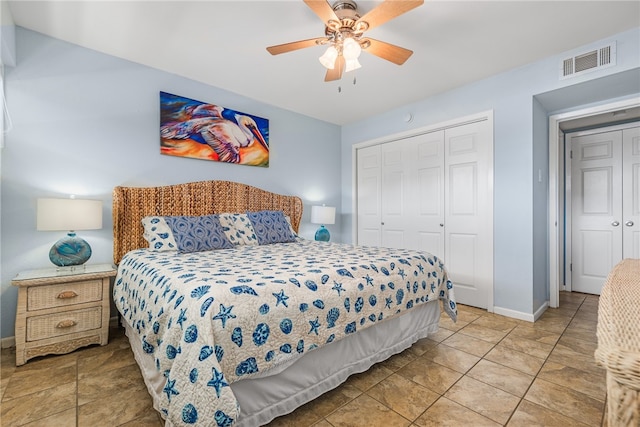 tiled bedroom with a closet and ceiling fan