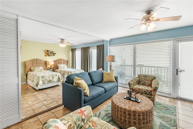 tiled bedroom featuring access to outside, beamed ceiling, and ceiling fan