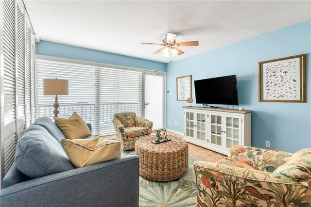 tiled living room featuring ceiling fan