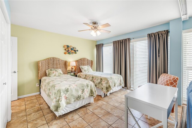 tiled bedroom with ceiling fan