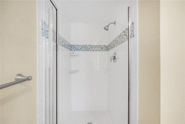 bathroom with a shower with door