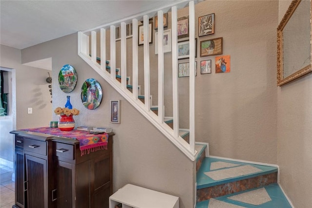 stairway featuring tile patterned flooring