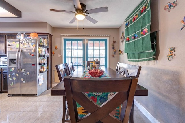 tiled dining space with ceiling fan