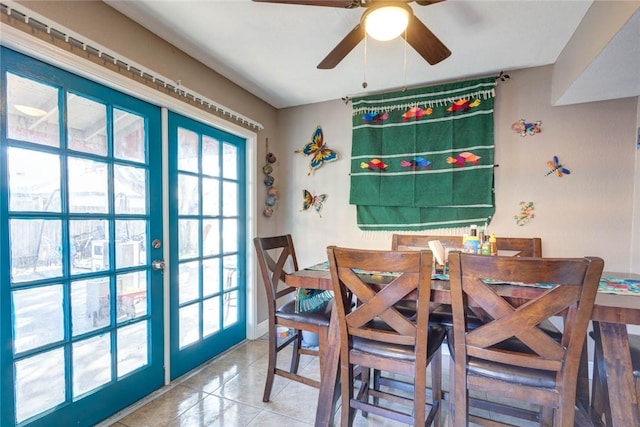 tiled dining area with ceiling fan