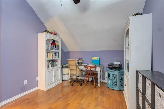 office space with ceiling fan, lofted ceiling, light hardwood / wood-style flooring, and built in shelves