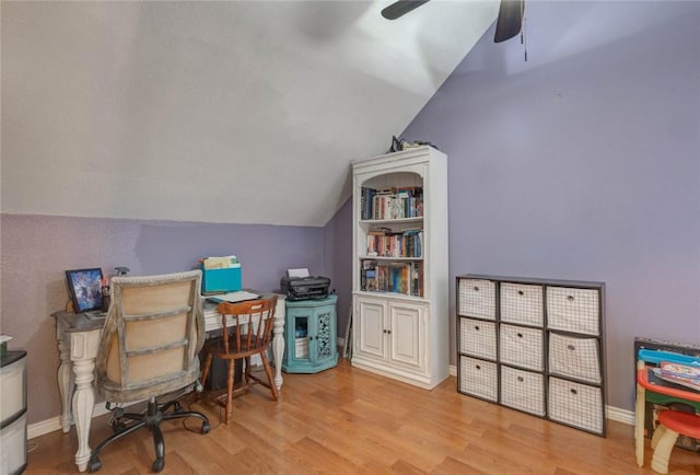 home office featuring ceiling fan, vaulted ceiling, and light hardwood / wood-style flooring