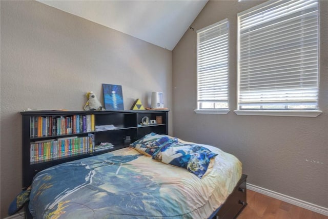 bedroom with wood-type flooring and lofted ceiling