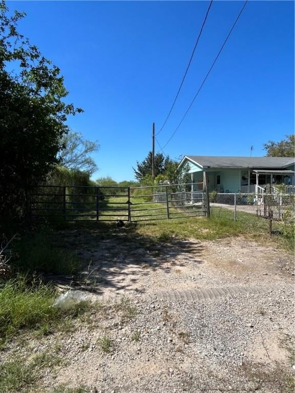 view of yard with driveway and fence