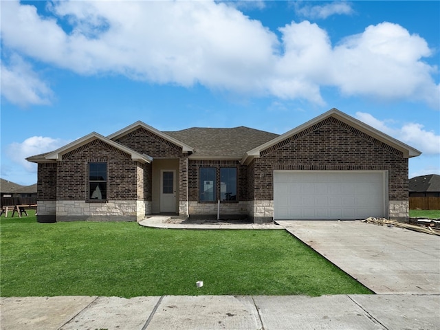 view of front of home featuring a garage and a front lawn