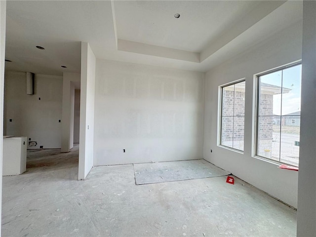 unfurnished room featuring a tray ceiling