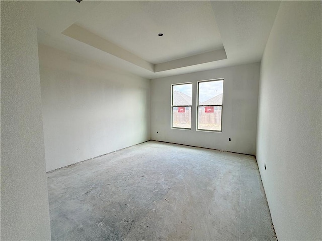 empty room featuring a tray ceiling