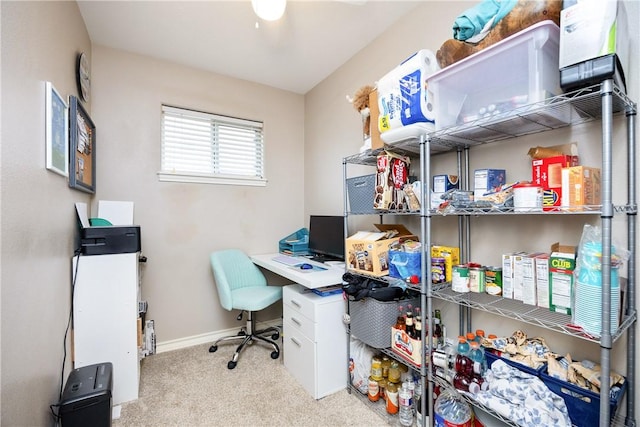 office area featuring light carpet and baseboards