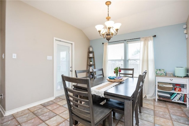 dining space with baseboards, a chandelier, and vaulted ceiling