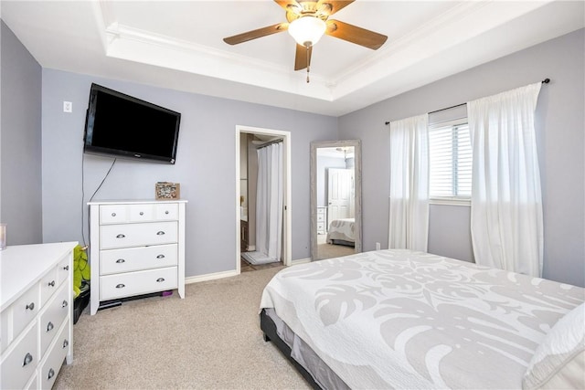 bedroom with light carpet, baseboards, a tray ceiling, and ornamental molding