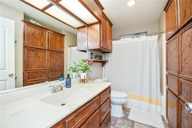 bathroom featuring toilet, a shower with curtain, and vanity