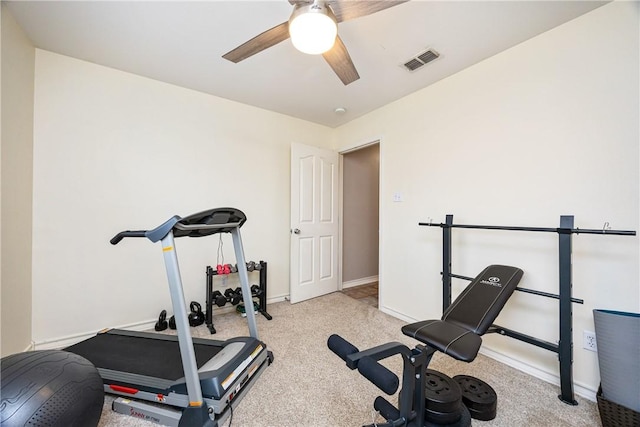 exercise room featuring light carpet, a ceiling fan, visible vents, and baseboards