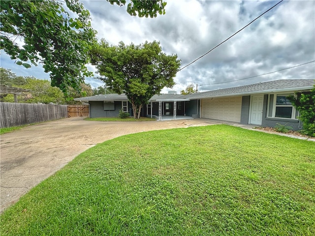 view of front of property featuring a garage and a front lawn