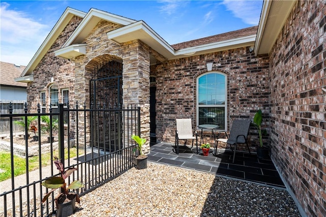 3902 Elvis Dr, Corpus Christi, TX 78414 - entrance to property featuring brick siding, a patio, and fence