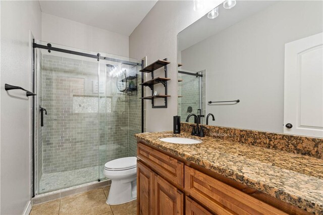 3902 Elvis Dr, Corpus Christi, TX 78414 - bathroom with vanity, tile patterned flooring, a shower stall, and toilet
