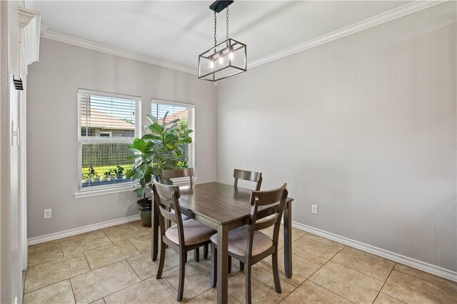 3902 Elvis Dr, Corpus Christi, TX 78414 - dining area with crown molding, light tile patterned flooring, baseboards, and a chandelier