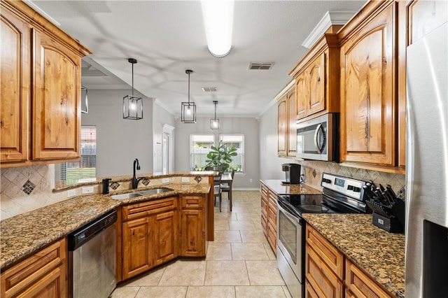 3902 Elvis Dr, Corpus Christi, TX 78414 - kitchen with stainless steel appliances, a sink, decorative backsplash, dark stone countertops, and ornamental molding