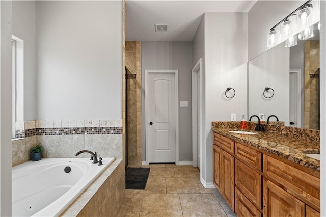 3902 Elvis Dr, Corpus Christi, TX 78414 - bathroom with a whirlpool tub, double vanity, tile patterned flooring, and tiled shower