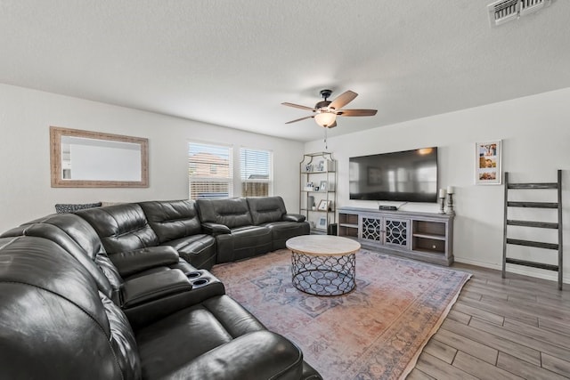 1947 Brandywine Dr, New Braunfels, TX 78132 - living area featuring a ceiling fan, wood finished floors, baseboards, and a textured ceiling