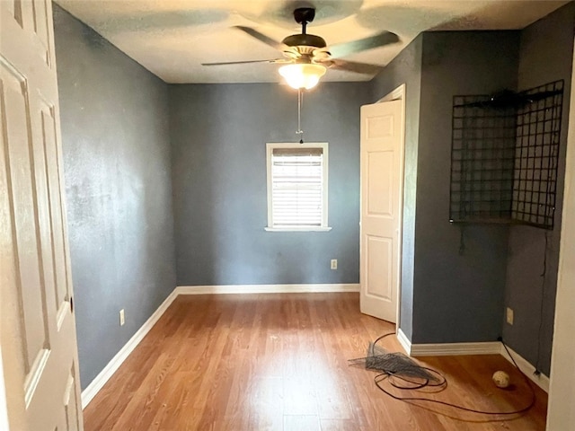 unfurnished bedroom with ceiling fan and light hardwood / wood-style flooring