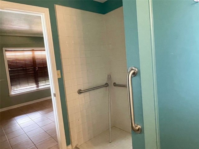 bathroom with tile patterned floors and a tile shower