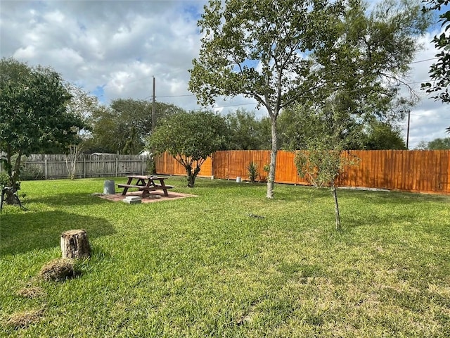 view of yard featuring an outdoor fire pit and a patio area