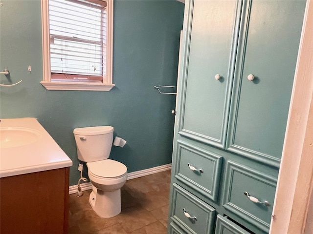 bathroom featuring toilet, vanity, and tile patterned floors