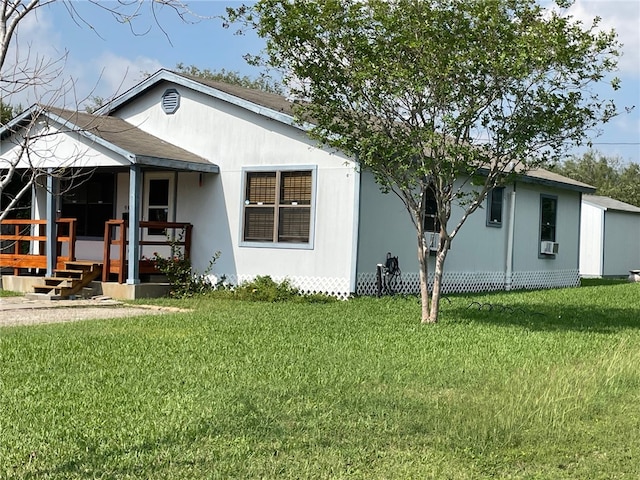 rear view of house featuring a yard and cooling unit