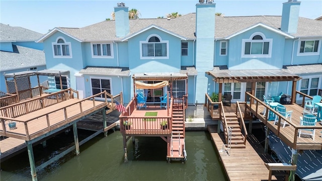 back of house with a deck with water view