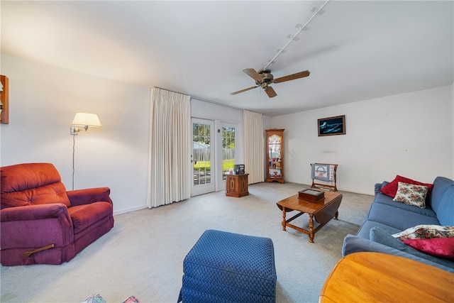 carpeted living room featuring track lighting and ceiling fan