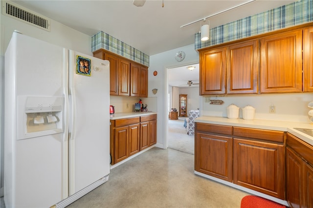 kitchen with ceiling fan and white refrigerator with ice dispenser