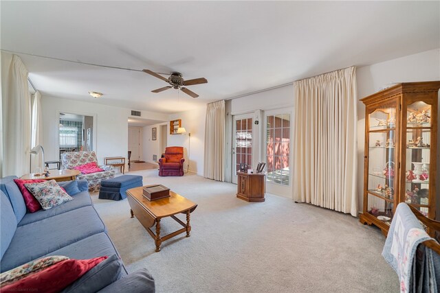 carpeted living room featuring ceiling fan and a healthy amount of sunlight