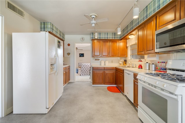 kitchen featuring white appliances, sink, and ceiling fan