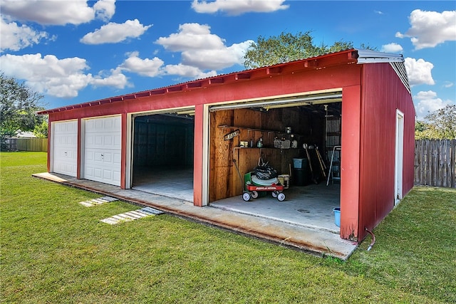 view of outbuilding with a garage and a yard