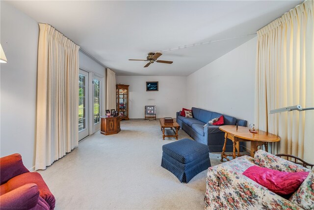 living room featuring light colored carpet and ceiling fan