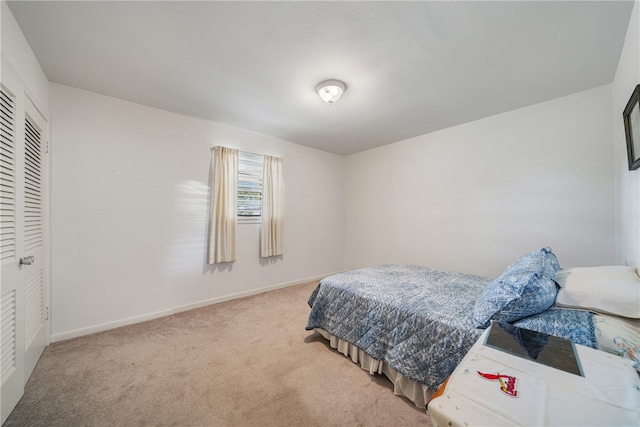 carpeted bedroom with a closet