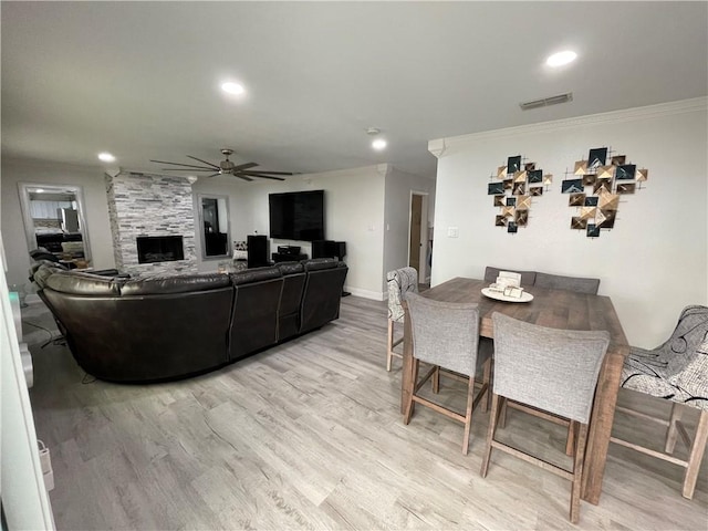 15321 Beaufort Ct, Corpus Christi, TX 78418 - living room featuring ceiling fan, light wood finished floors, ornamental molding, recessed lighting, and a fireplace