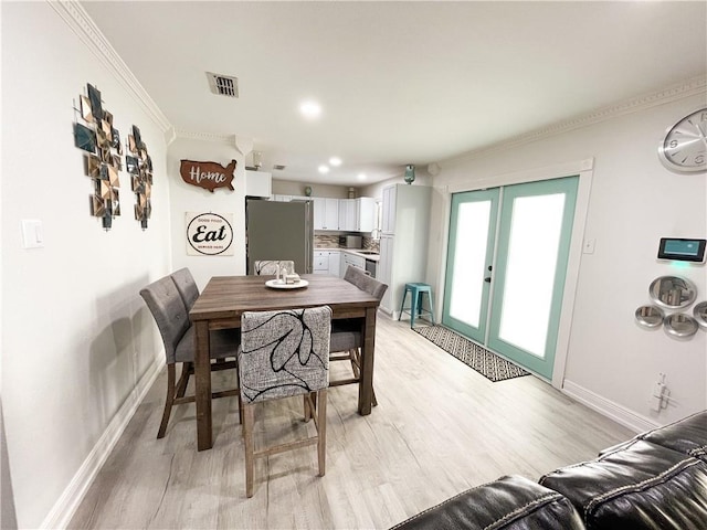 15321 Beaufort Ct, Corpus Christi, TX 78418 - dining space with french doors, light wood-style floors, crown molding, and recessed lighting