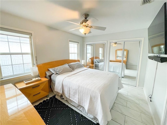 15321 Beaufort Ct, Corpus Christi, TX 78418 - bedroom featuring light marble finish floors, two closets, and ceiling fan