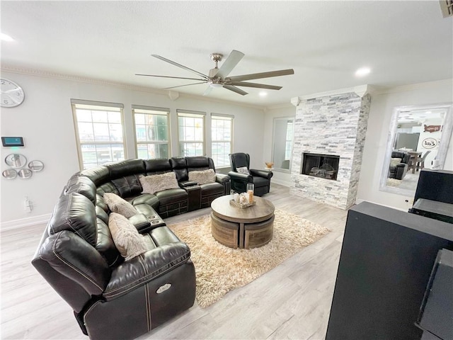 15321 Beaufort Ct, Corpus Christi, TX 78418 - living area featuring crown molding, a ceiling fan, a stone fireplace, and wood finished floors