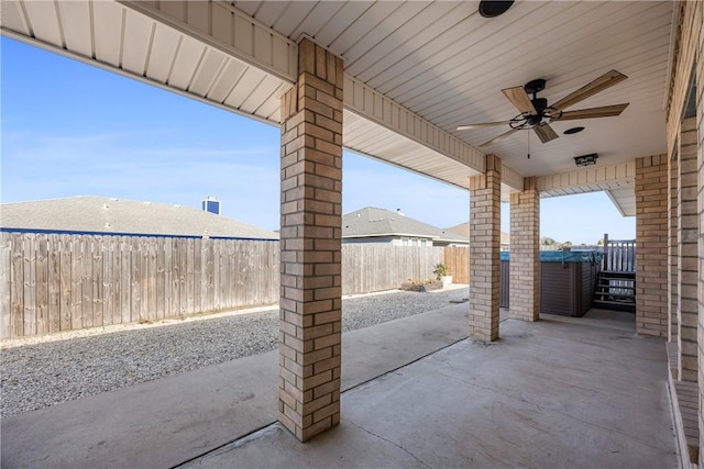 view of patio / terrace featuring a ceiling fan, a fenced backyard, and a hot tub