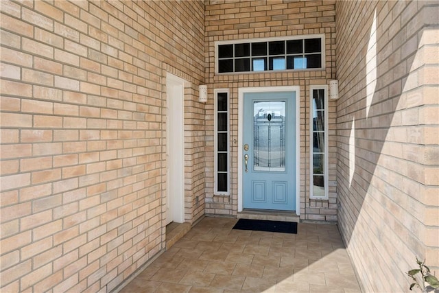 property entrance featuring brick siding